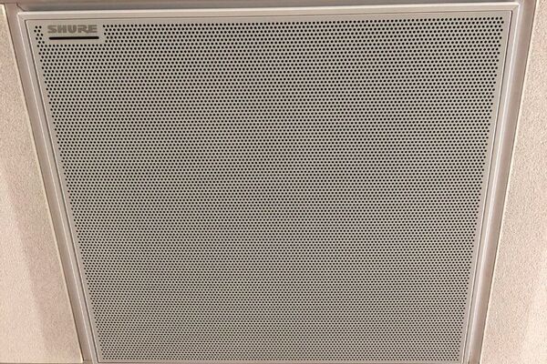 White 2¿ x 2¿ tile mounted in the ceiling to provide microphone coverage over student seating