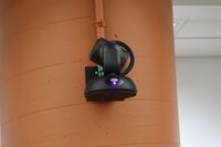 Camera mounted to a wall and instructor enabled adjustments to the lens to allow the instructor to be "seen" by the camera in more locations around the room