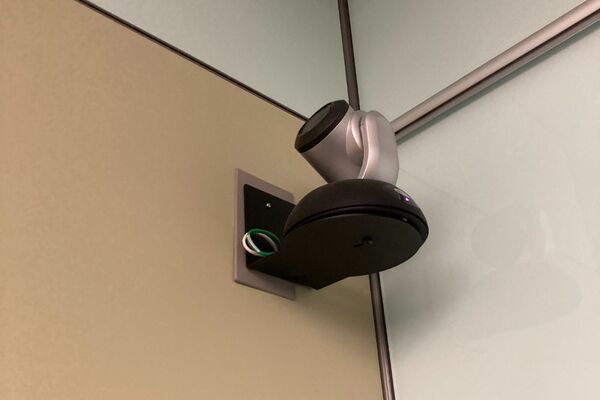 Camera mounted to a wall and instructor enabled adjustments to the lens to allow the instructor to be "seen" by the camera in more locations around the room