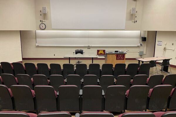 Front of room view with lectern on right in front of markerboard