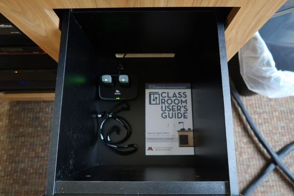 Pedestal - inside view of drawer showing two wireless mics in charging base