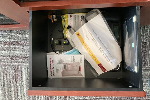 Pedestal - inside view of drawer showing two wireless mics in charging base