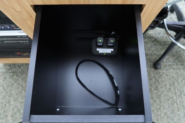 Pedestal - inside view of drawer showing two wireless mics in charging base