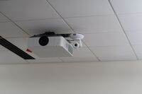 Camera mounted to ceiling and instructor enabled adjustments to the lens to allow the instructor to be "seen" by the camera in more locations around the room