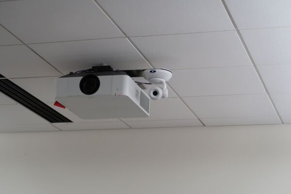 Camera mounted to ceiling and instructor enabled adjustments to the lens to allow the instructor to be "seen" by the camera in more locations around the room