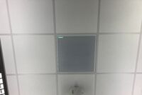 White 2¿ x 2¿ tile mounted in the ceiling to provide microphone coverage over student seating