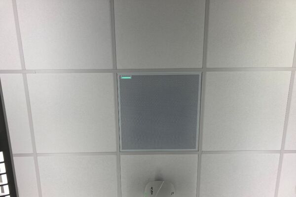 White 2¿ x 2¿ tile mounted in the ceiling to provide microphone coverage over student seating