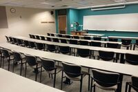 Front of room view with lectern on left in front of markerboard 