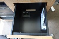 Pedestal - inside view of drawer showing two wireless mics in charging base