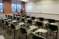 Front of room view with lectern on left in front of markerboard