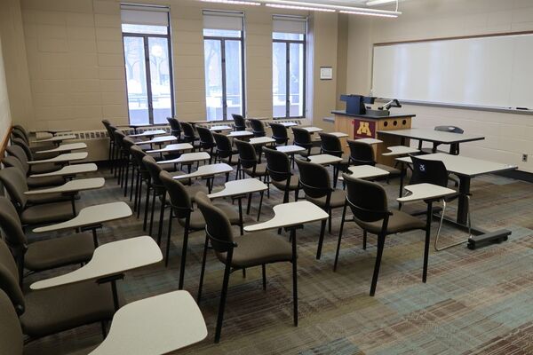 Front of room view with lectern on left in front of markerboard 