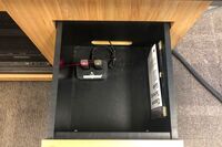 Pedestal - inside view of drawer showing two wireless mics in charging base