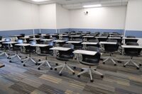 Back of room view of student tablet arm seating and camera on center of rear wall