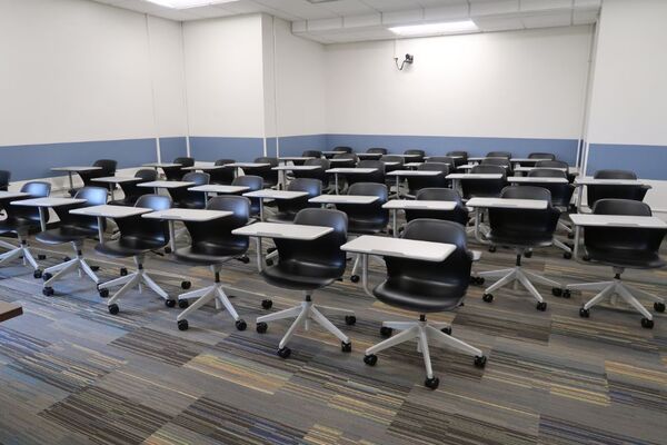 Back of room view of student tablet arm seating and camera on center of rear wall