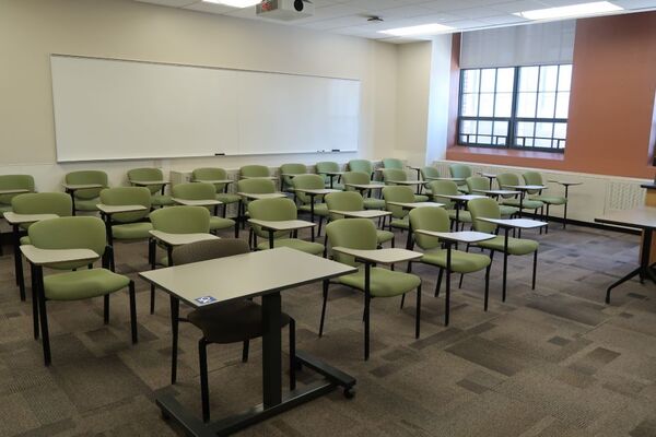 Back of room view of student tablet arm seating and markerboard on back wall