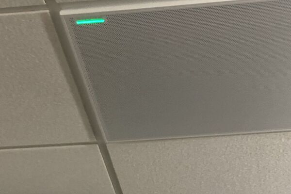 White 2¿ x 2¿ tile mounted in the ceiling to provide microphone coverage over student seating