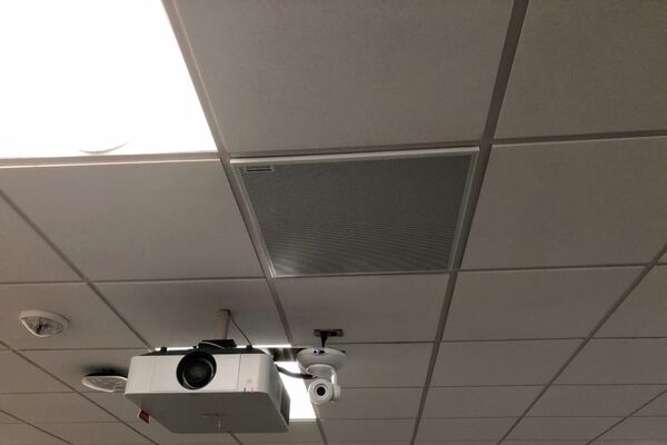 White 2¿ x 2¿ tile mounted in the ceiling to provide microphone coverage over student seating