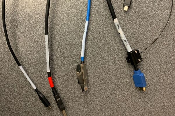 Pedestal - laptop cable connections with cables pulled out showing cable ends