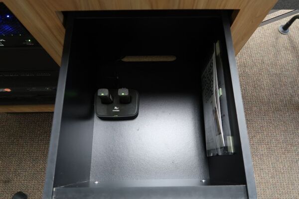 Pedestal - inside view of drawer showing two wireless mics in charging base