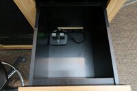 Pedestal - inside view of drawer showing two wireless mics in charging base