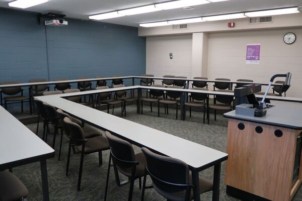 Back of room view of student tiered fixed table and chair seating 