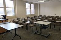 Rear of room view of student tablet arm chair seating