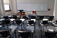 Front of room view with lectern on left in front of markerboard