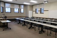 Back of room view of student tablet arm seating and markerboard on rear wall