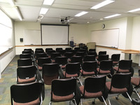 Photo of front of room from back of room with tablet armchairs on casters.