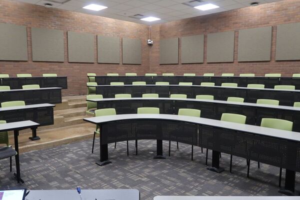  Back of room view of student tiered fixed-table and chair seating