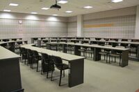 Back of room view of student tiered fixed-table and chair seating 