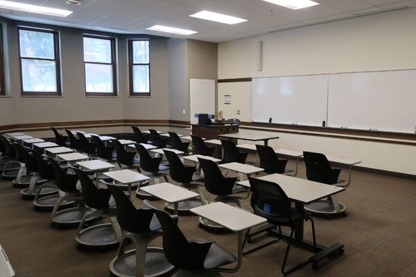 Front of room view with lectern on left in front of markerboard 