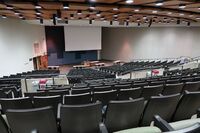 Front of room view with lectern center in front and projection screen lowered