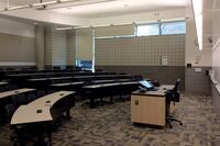 Back of room view of student tiered fixed-table and chair seating