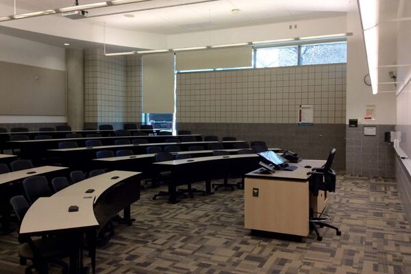 Back of room view of student tiered fixed-table and chair seating