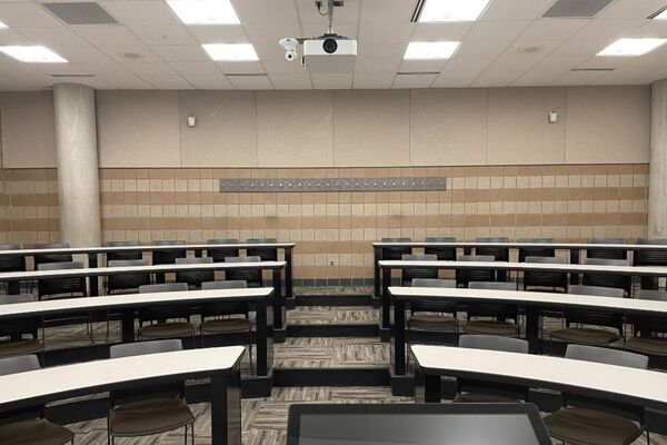 Back of room view of student tiered fixed-table and chair seating