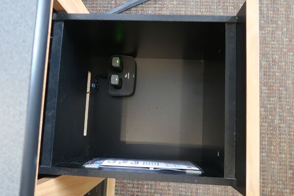 Pedestal - inside view of drawer showing two wireless mics in charging base