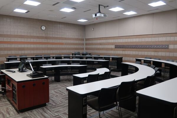 Back of room view of student tiered fixed-table and chair seating