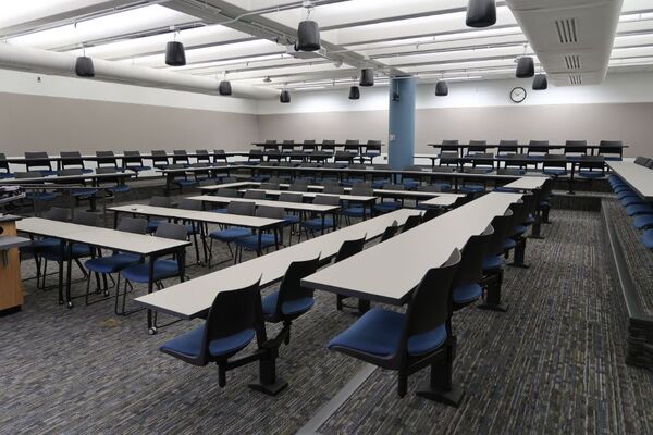 Back of room view of student tiered fixed table and chair seating 