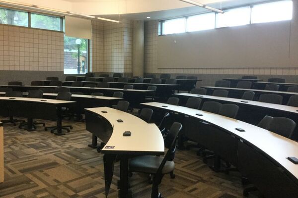 Back of room view of student tiered fixed-table and chair seating