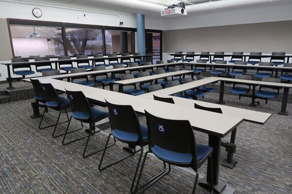 Back of room view of student tiered fixed table and chair seating