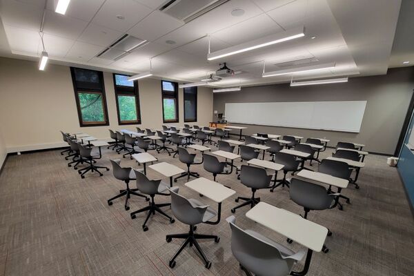 Front of room view with lectern on left in front of markerboard 