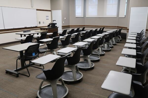 Front of room view with lectern on right in front of markerboard