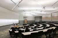 Front of room view with lectern center in front of markerboard 