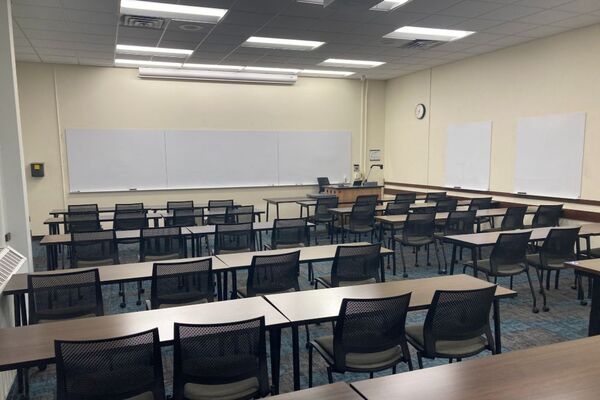 Front of room view with lectern on right in front of markerboard