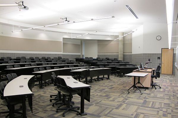 Back of room view of student tiered fixed-table and chair seating