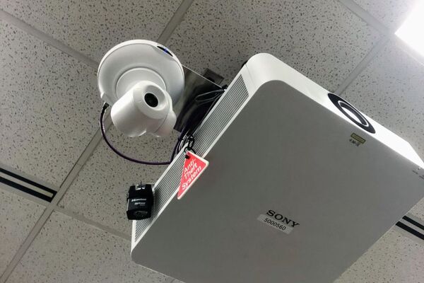 Camera mounted to ceiling and instructor enabled adjustments to the lens to allow the instructor to be "seen" by the camera in more locations around the room