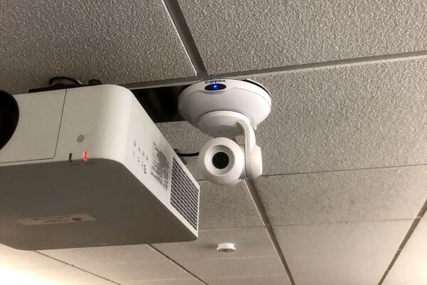 Camera mounted to ceiling and instructor enabled adjustments to the lens to allow the instructor to be "seen" by the camera in more locations around the room