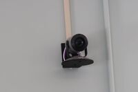 Camera mounted to a wall and instructor enabled adjustments to the lens to allow the instructor to be "seen" by the camera in more locations around the room