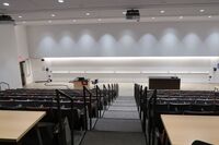 Front of room view with lectern on left side and demonstration bench on right side